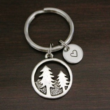 two pine tree outlines in circle keychain