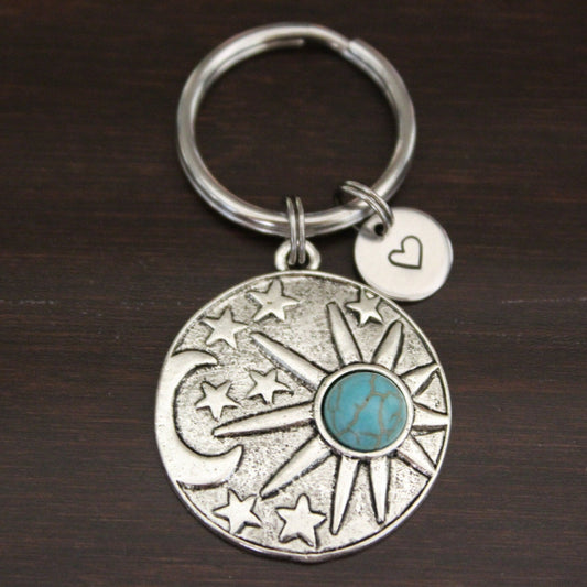 moon, stars and sun with turquoise insert on round keychain