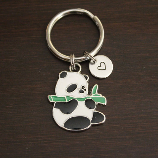 black and white panda charm holding a green bamboo keychain