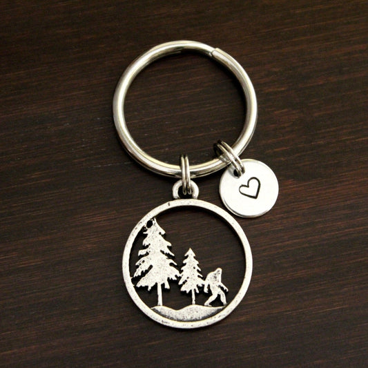 Sasquatch with 2 pine trees round keychain