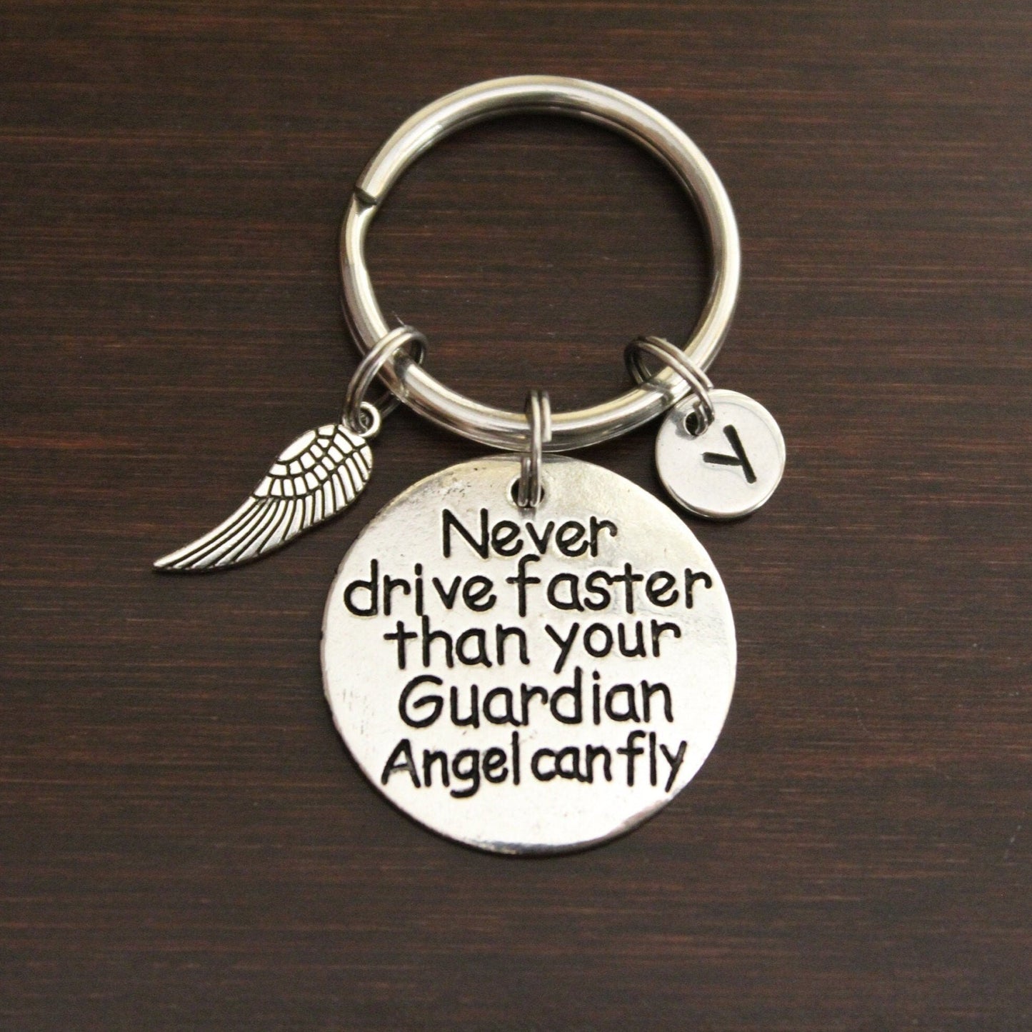 never drive faster than your guardian angel can fly keychain with wing