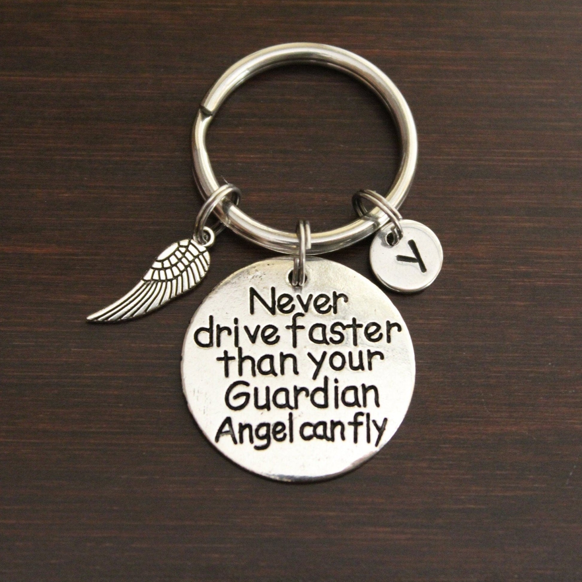 never drive faster than your guardian angel can fly keychain with wing