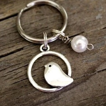 bird sitting in a circle keychain